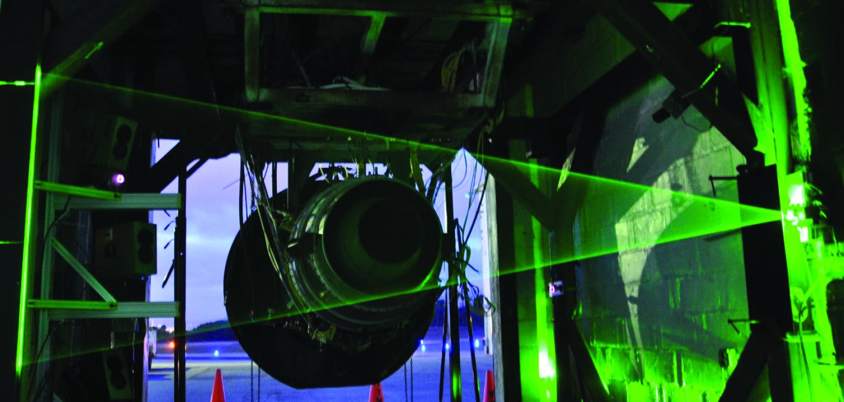 A jet engine exhaust being tested with a laser beam