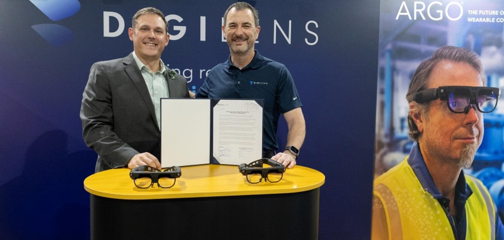 Ashley Stowe, director of Oak Ridge Enhanced Technology and Training Center (l), and Chris Pickett, DigiLens CEO (r), both sign government contracts